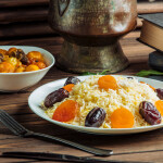 plate of azerbaijani pilaf rice served with dried fruits and roasted beef